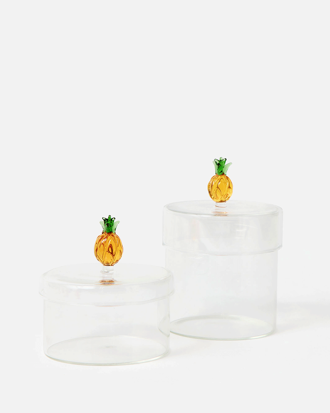Glass storage pots with a pineapple lid, filled with cotton balls